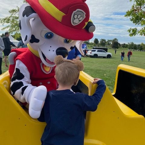 Fire fighting dog Fire fighting dog with kid saying hi